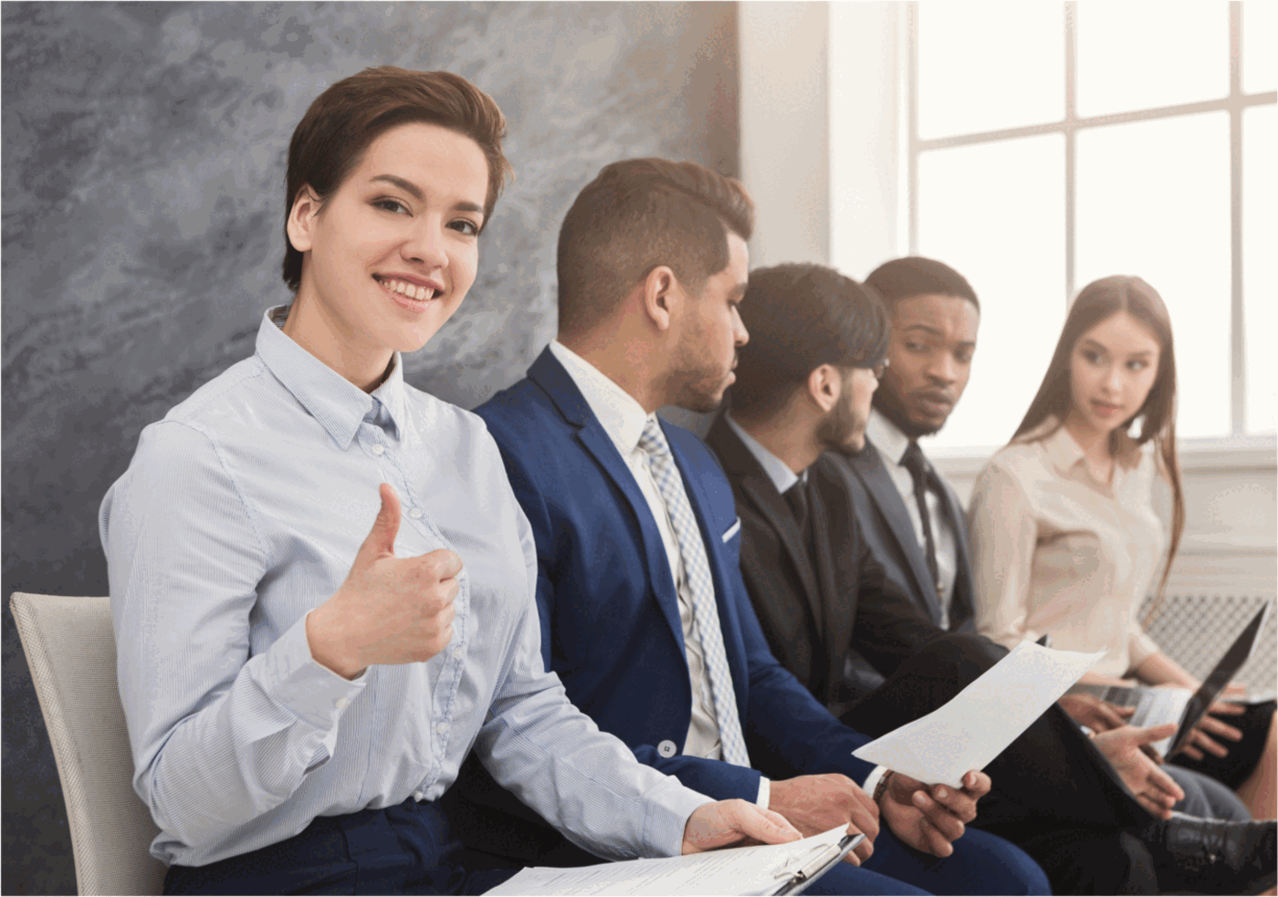 Candidates waiting to be interviewed, resumes in hand